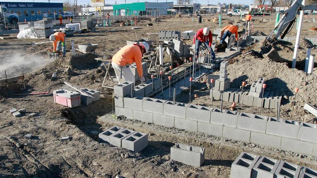 Construction personnel work Monday morning assembling a block building at the Columbia Gardens Wine and Artisan Village on east Columbia Drive in Kennewick. The $3.4 million project, a joint effort between the Port of Kennewick and the city of Kennewick, is designed to bring the city’s first wine tasting rooms and production facilities to the historic waterfront. The first phase includes two buildings to house tasting rooms and wine production, and a third building that will be a shared barrel-storage/production space to support two production wineries. Port staff will make a recommendation regarding potential tenants for those wine tasting/production buildings to the port’s Board of Commissioners at their next meeting on December 13. Concrete flooring in two buildings at the site is scheduled to be poured this week for the project scheduled for completion in July 2017.