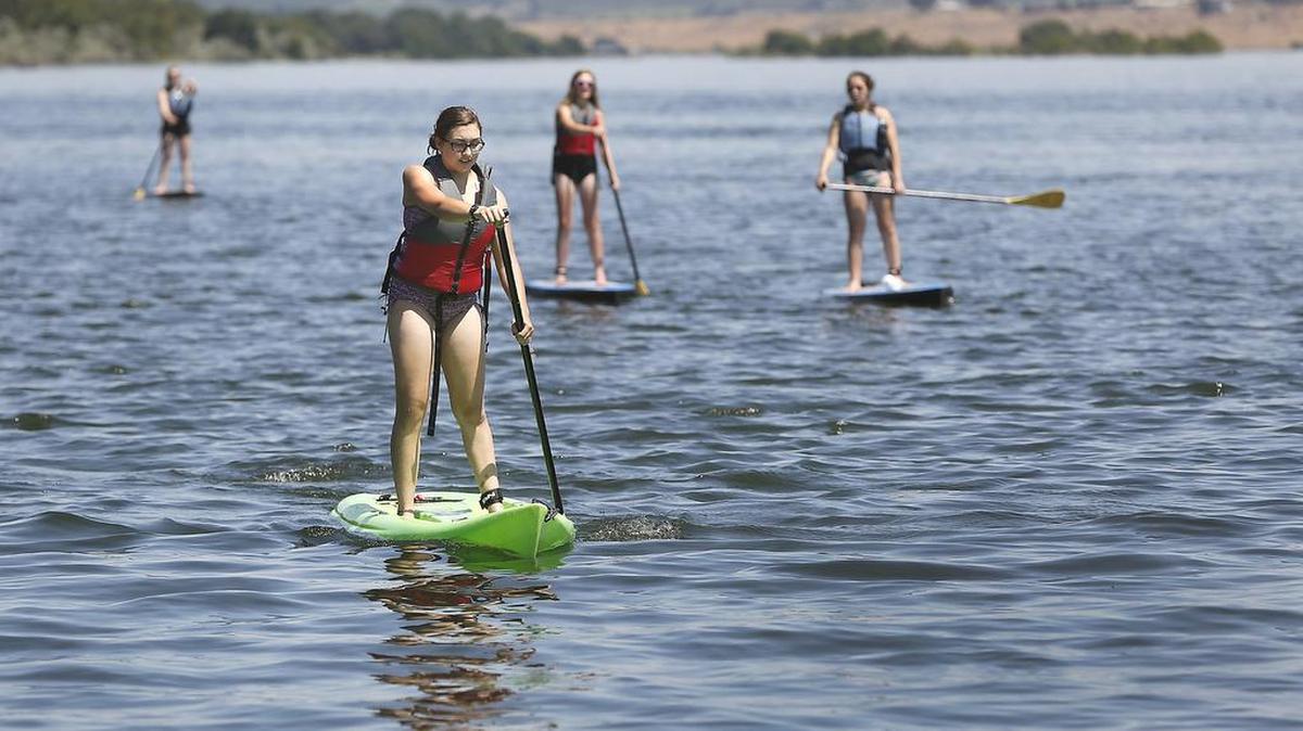 Paddleboarders make their way down the Columbia River.