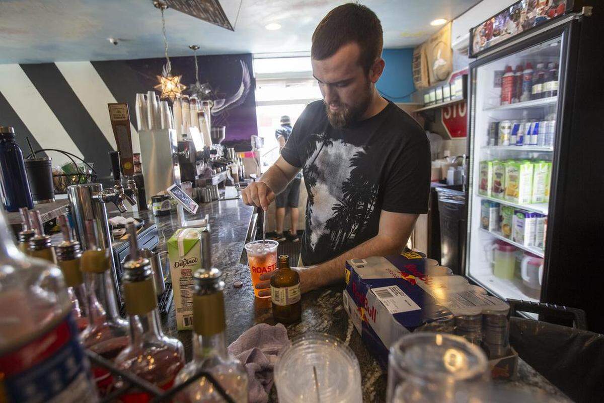 Barista Blake Clatterbuck makes a beverage at Roasters Coffee in Kennewick.