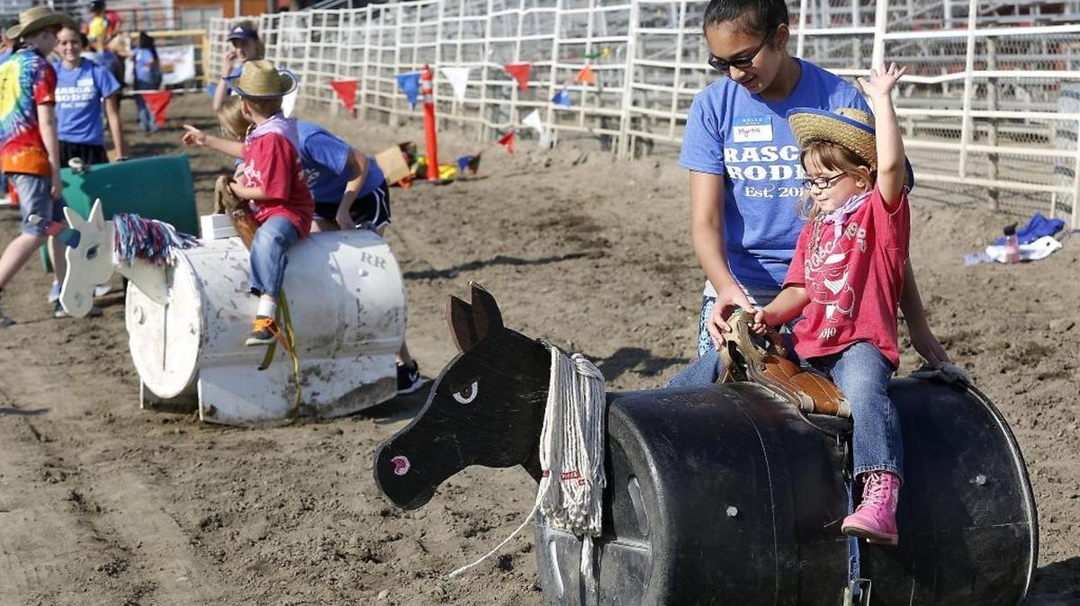 Three-year-old Sophia Harris of West Richland practices her one-hand riding technique Friday during a Rascal Rodeo event in the rodeo arena at the Benton Franklin Fair & Rodeo in Kennewick. The free event is for anyone with a mental or physical disability. Dozens of participants tried horse rides, roping practice, wagon rides and barrel racing. Harris was with her grandmother Wendy Slattery. Check out a photo gallery at tricityherald.com/galleries.