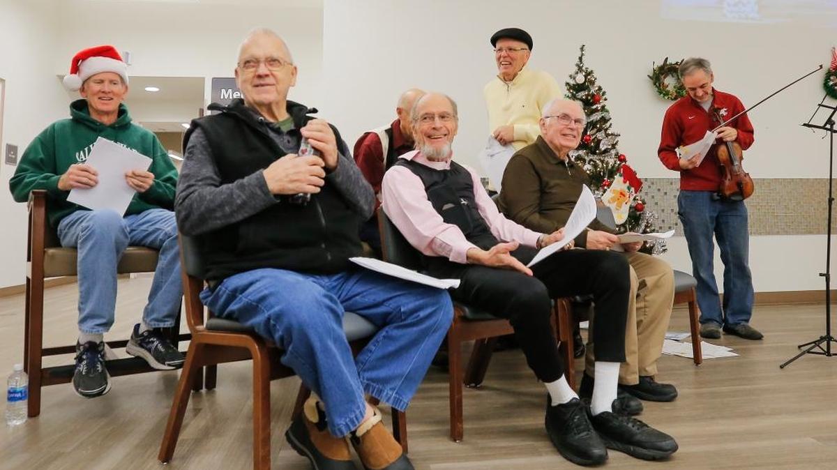 The Parkinson’s Loud Crowd smile after finishing up caroling inside the Kadlec Heathplex in Richland on Tuesday. The Parkinson’s disease patients sing Christmas carols as a part of their speech therapy. The progressive nervous system disorder can cause speech problems.