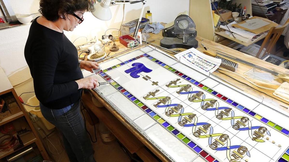 Stained glass artist Virginia Davidson works Tuesday on her tribute to Pi Day, an annual celebration of the mathematical constant, at her home in Rancho Reata near Kennewick. Davidson was inspired to make the colorful mathematical creation after her husband, Jim, derived a simple version of the formula first identified in 1655.Pi Day is observed on March 14 since 3, 1, and 4 are the first three significant digits of Pi — the ratio of a circle’s circumference to its diameter.