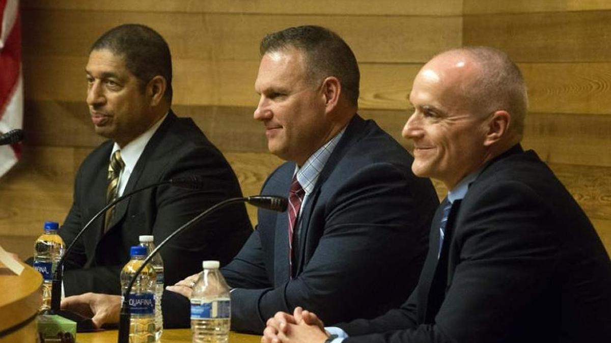 Eugene Police Department chief candidates Bruce Marquis, Richland Police Chief Chris Skinner and Mike Lester wait for the first question at a candidate forum in Eugene on Tuesday night.