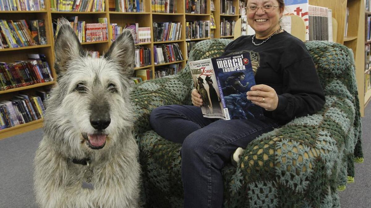 Patricia Briggs at Adventures Underground in Richland in 2014 signing her comic book, Mercy Thompson: Hopcross Jilly. The store’s mascot Charley — an Irish Wolfhound and German Shepherd mix — is featured on a special variant cover of the comic.