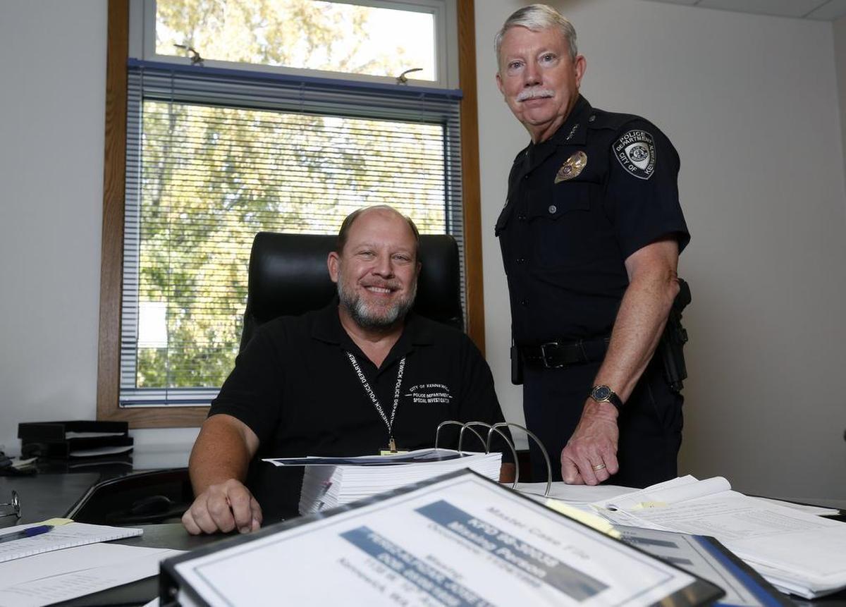 Former Richland police Capt. Al Wehner, left, and Kennewick Police Chief Ken Hohenberg look over cold cases. Wehner has been working with Kennewick police since 2015 to review the department’s cold cases.