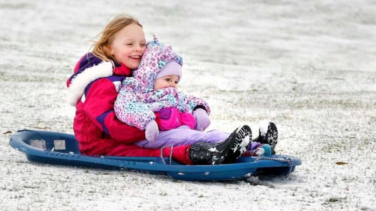 Adelynn Reiboldt, 5, and her 19-month-old sister, Kaydence, took advantage of the half inch of snow Nov. 24 to go sledding in Richland.