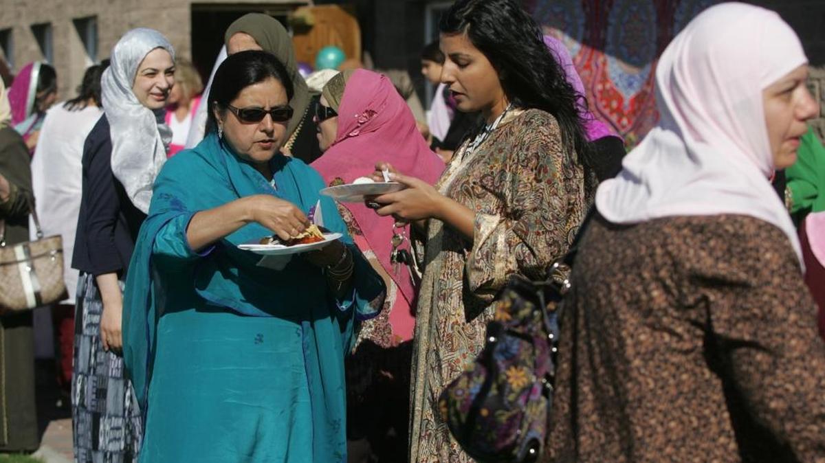 Sabiha Khan, left, and her daughter Zahra Khan, both of Pasco, share some thoughts outside the Islamic Center of the Tri-Cities in Richland on the Islamic holiday of Eid ul-Fitr, marking the end of the Ramadan fasting in this file photo.
