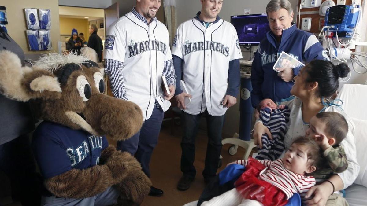 Susan Gonzalez, of Kennewick, holds her son Daniel Martinez, who was born on January 12th, daughter Kandee Martinez, 11 months, and son Andrew Martinez, 2, as they talk with members of the Mariners Caravan. See a video at www.tricityhearld.com/video.