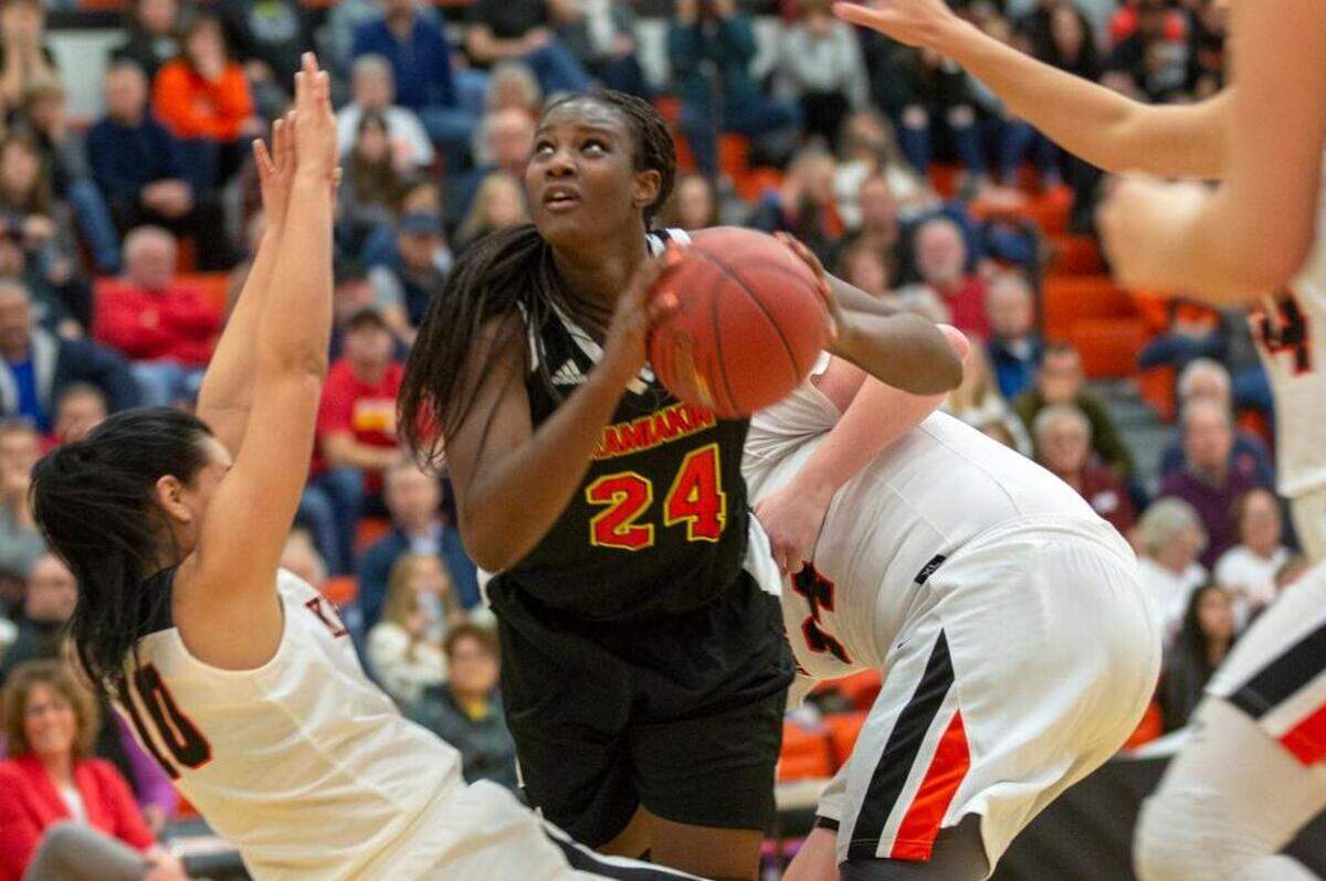 Kamiakin’s Oumou Toure (24) attempts to shoot the ball while being surrounded by Kennewick’s defense during a high school girls basketball game at Kennewick on Friday.