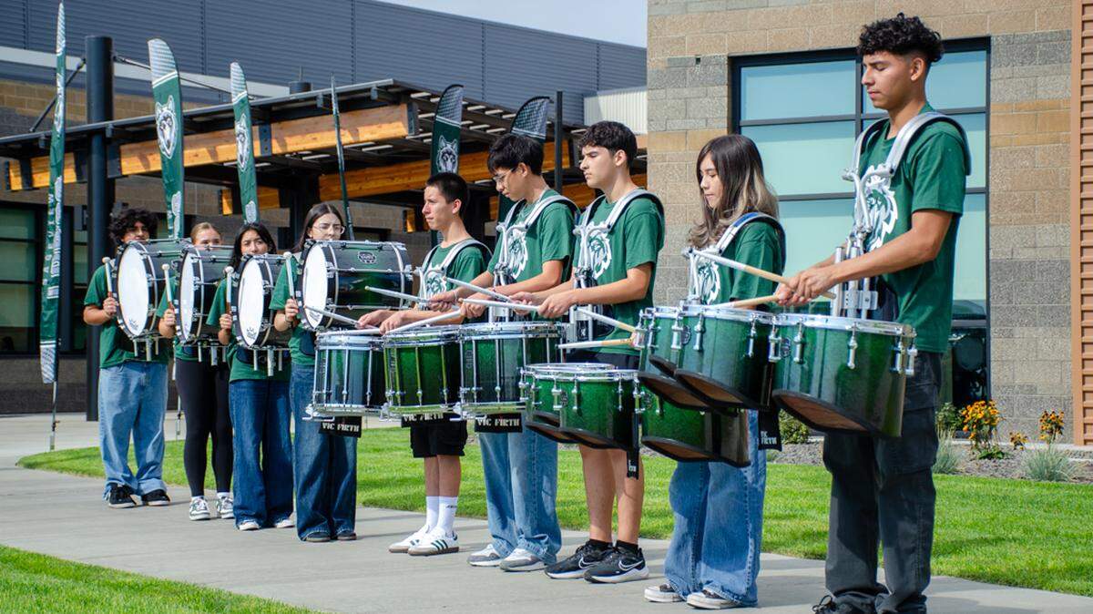 The Sageview High School Lobos marching band plays a number at the ribbon cutting ceremony Monday, Aug. 18, christening their brand new high school.