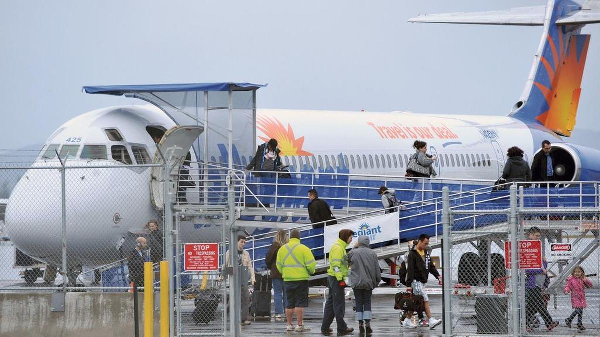 Passengers disembark from an Allegiant Air flight that had just taken off from Bellingham International Airport and had to turn around and make an emergency landing in 2012 because of smoke in the plane’s cabin.