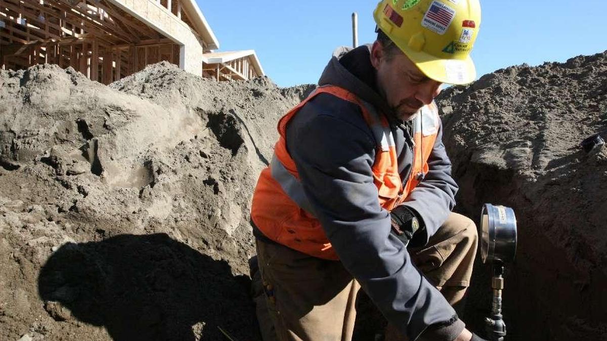 A Cascade Natural Gas employee tests a gas line in Pasco.
