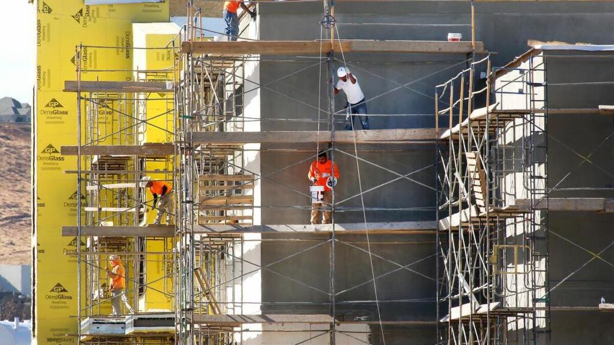 Construction workers work on the exterior of the new Fairchild Cinemas building in Richland. Construction jobs are a contributing factor to the Tri-Cities having the lowest unemployment rate in seven years. The theater, on Duportail Street, will house 12 screens and have 1,100 reclining leather seats along with other premium amenities.