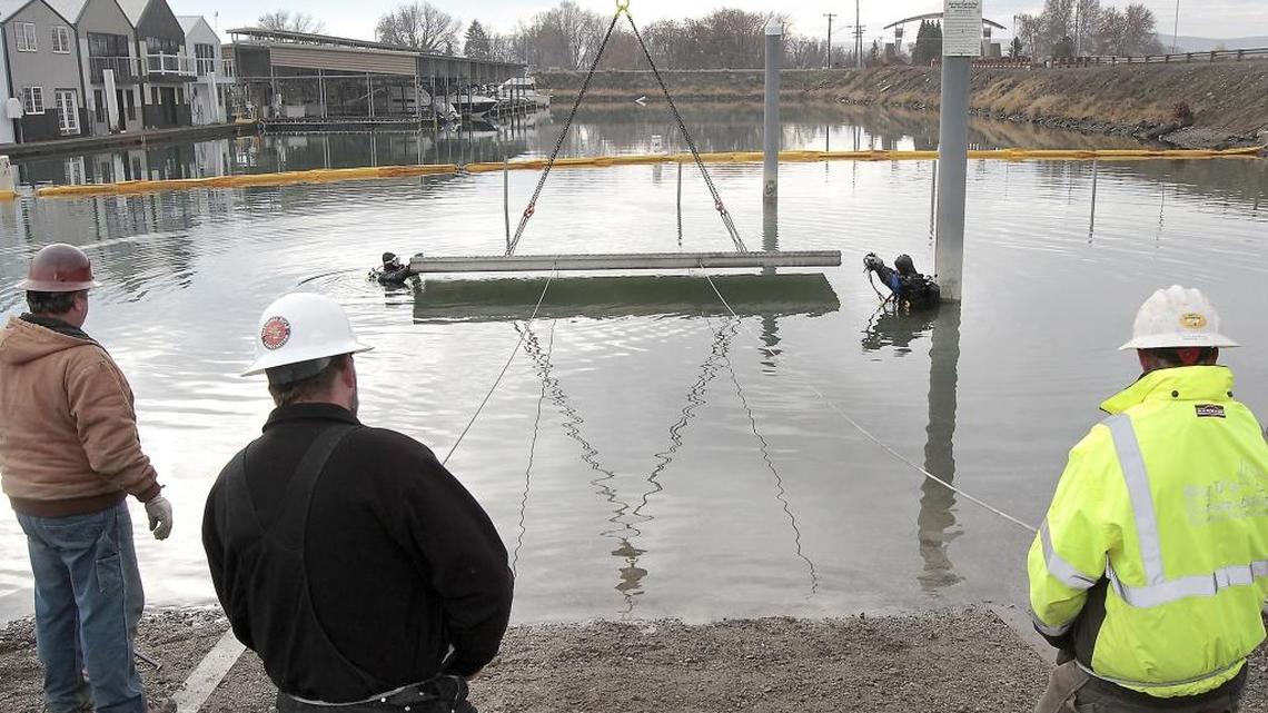 Divers Buddy Talbott, left, and Mark Allen of Allen Marine Services work together Friday fitting into place precast concrete boat ramp panels for the boat launch on Clover Island in Kennewick. A Lampson International crane is lifting the 38 panels, each weighing close to 4 tons, for the two new 80 foot long ramp lanes. The work is part of the second phase to rebuild the Port of Kennewick’s boat launch facility. Working from land, from left, are: Bill Gwinn of Lampson International, Marshal Nelson and Kody McFarland, both of Big D’s Construction of Pasco. The boat launch is expected to re-open by the end of March. Watch a video at: www.tricityherald.com/video
