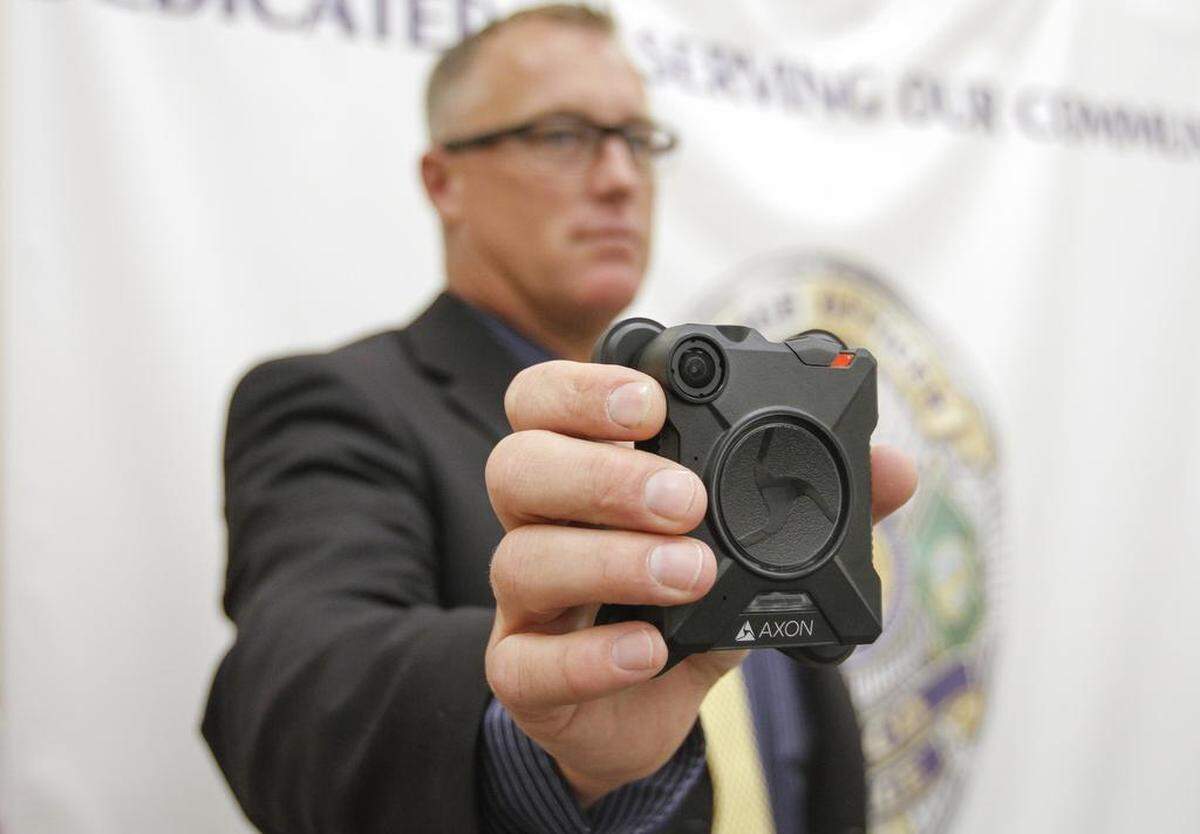 In 2018, Pasco police Sgt. Scott Warren holds an Axon police body camera that Pasco officers were training to use.