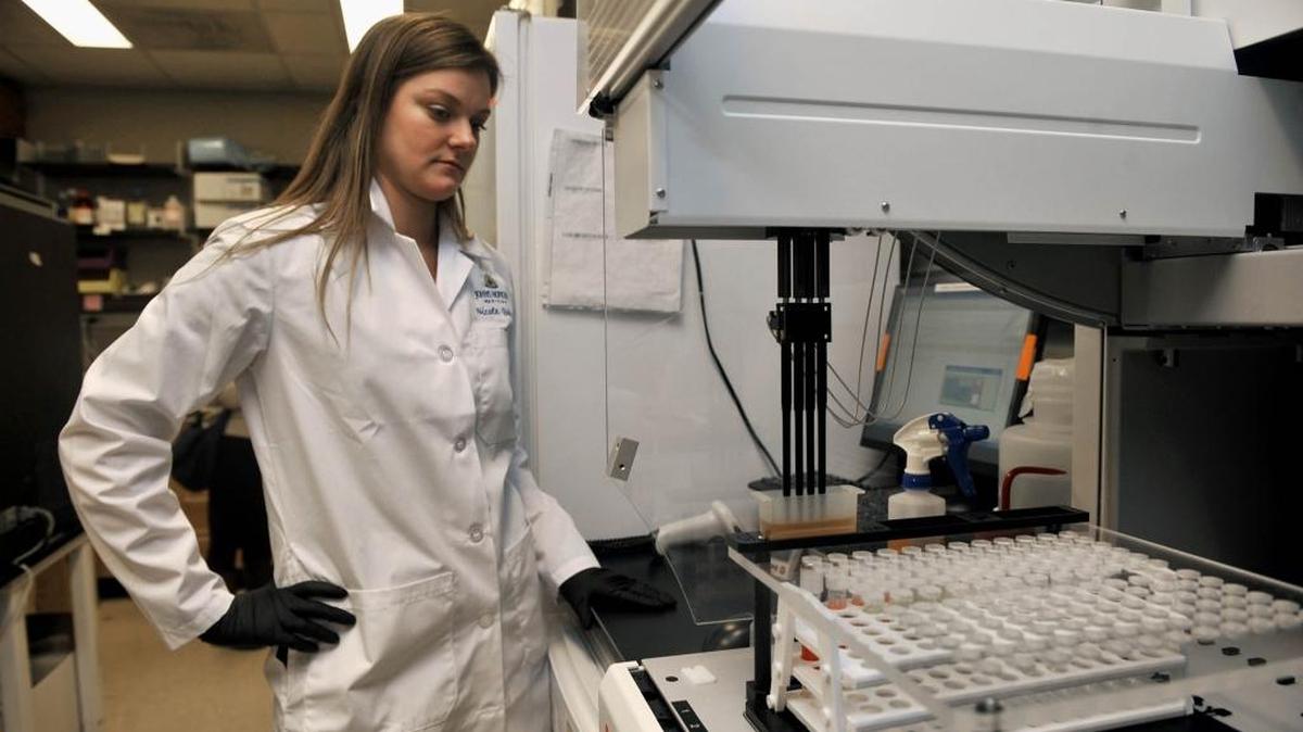 Research specialist Nicole Quinn of Johns Hopkins Medicine tests samples for sexually transmitted diseases.