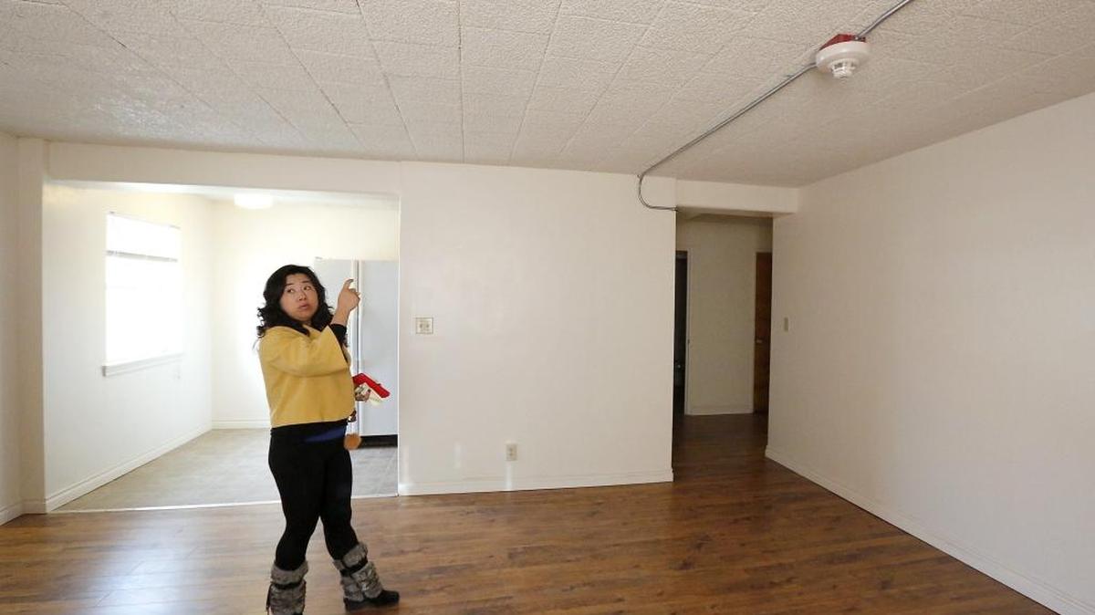 Linda Guo, owner of the Sacajawea Apartments, points out some of the updates to a remodeled one-bedroom apartment at the Pasco complex that was damaged by fire in July 2013. All the rooms and hallways now have commonly wired fire alarms and smoke detectors.