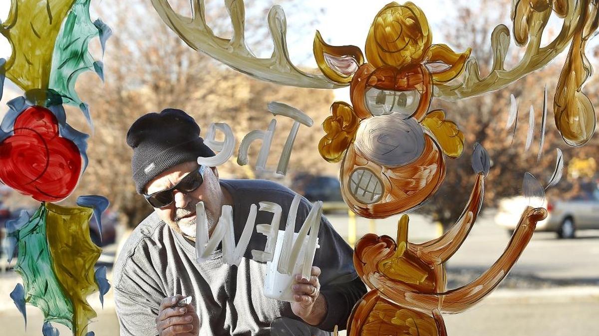 Lee Moses, of Signs & Wonders by Moses, finishes the lettering for "The New Guy" painting of a pizza dough tossing moose that is all tangled up Tuesday morning on the outside of a window at the Papa Murphy's pizza store on Gage Boulevard in Richland. Watch a video at: tricityherald.com/video