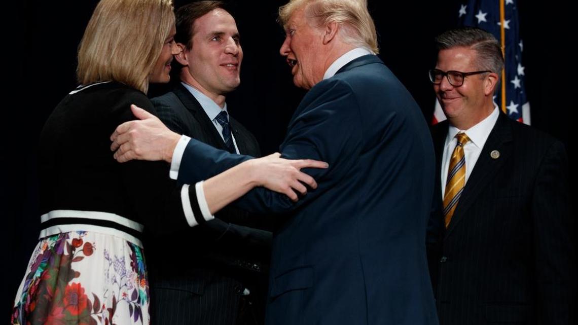 President Donald Trump greets Ret. Army Major Scott Smiley and his wife Tiffany Smiley on Thursday during the National Prayer Breakfast in Washington, D.C.