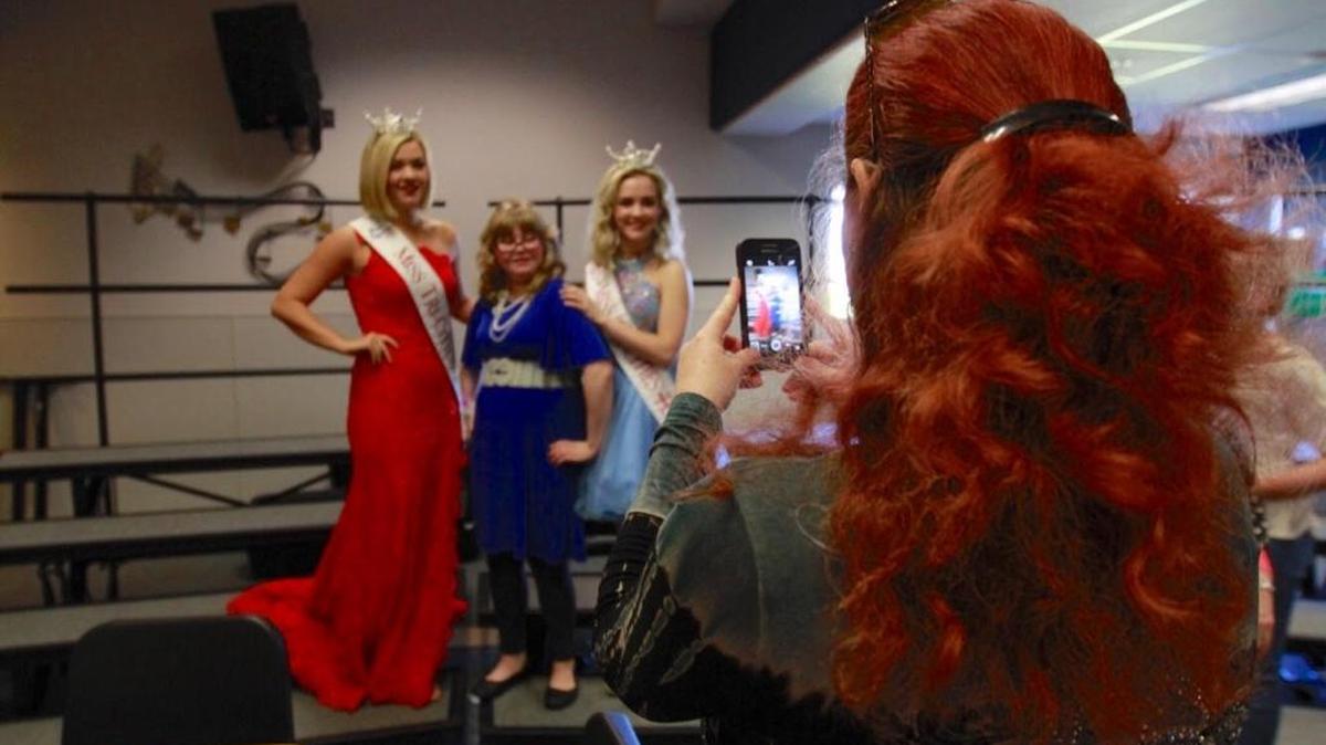 Ronnie Goodnight, 11, of Richland, poses with Miss Tri-Cities Taylor Plunkett, left, and Miss Tri-Cities Outstanding Teen Abby Faulk, as her mom, Ericca Goodnight, snaps a photo, before Saturday’s Sparkle & Shine pageant in Richland. The pageant, put on by Kadlec Therapy, is for special needs children.