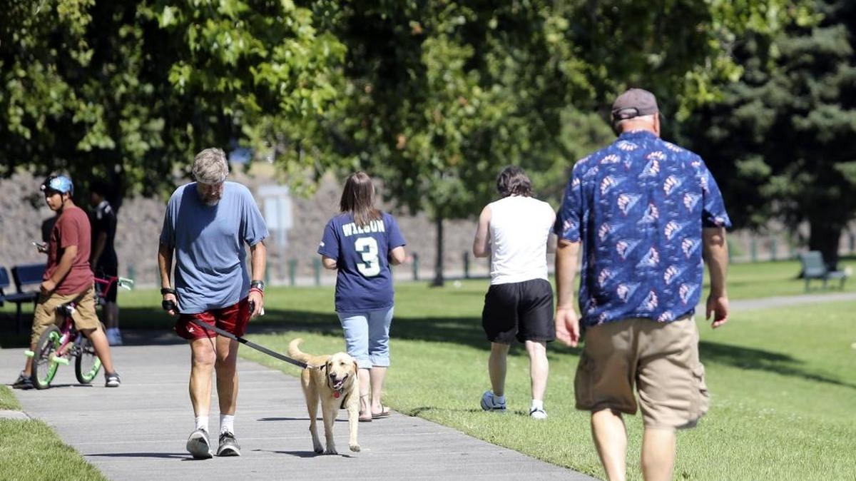 Pedestrians walk along the waterfront trail at Howard Amon Park in Richland. The city is working on a project that would remove up to 25 trees to widen the popular path.