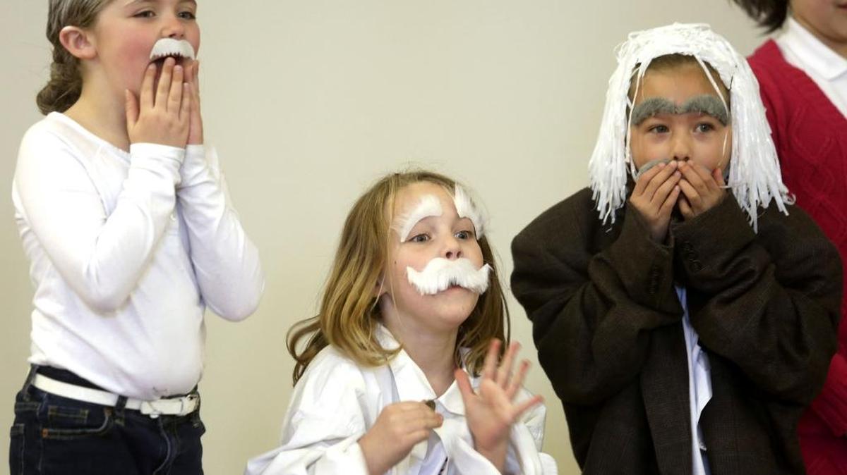 From left, first-graders Elli Wilson, Peydon Lyman and Siena Dorow participate in a costume contest Friday dressed as Albert Einstein during Pi Day and a celebration of Einstein’s birthday at St. Joseph’s Public School in Kennewick.