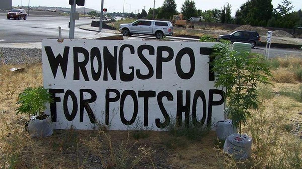 West Richland police officers on Sunday confiscated 10 pot plants that were left next to an older sign protesting a proposed marijuana retail store.