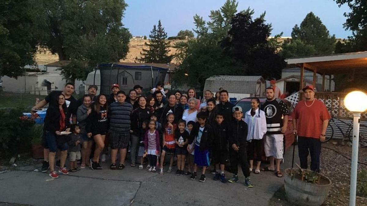 Loy Vannapho, 75, of West Richland (center) stands in the middle of his most recent family portrait. Vannapho went missing on Aug. 11.