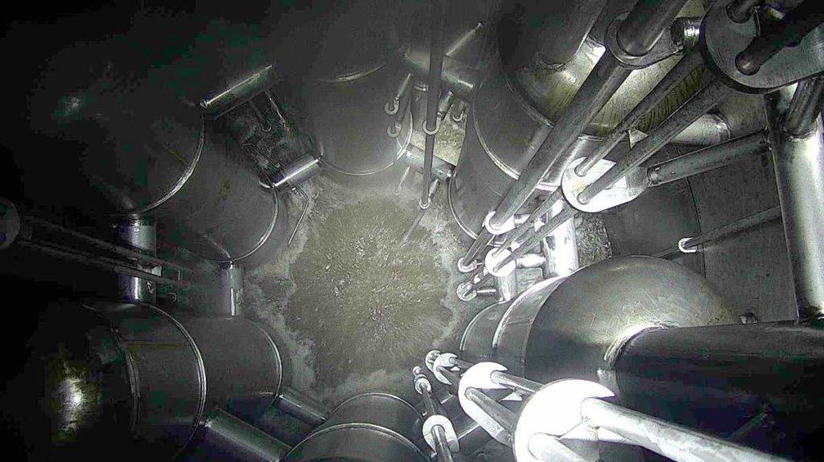 The inside of the test vessel contains six pulse jet mixers used to keep the solids suspended in the simulated radioactive waste. The pulse jet mixers draw in waste and expel it, similar in operation to a turkey baster. This set of tests is to verify the control mechanism for mixer operations.