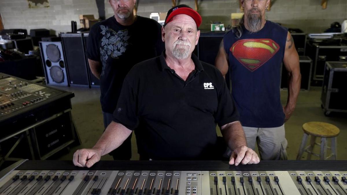 Tom Fortier, center, sits at a digital soundboard with longtime employees Dave Harris, right, and Jeremy Burkett at Concert Production Services.