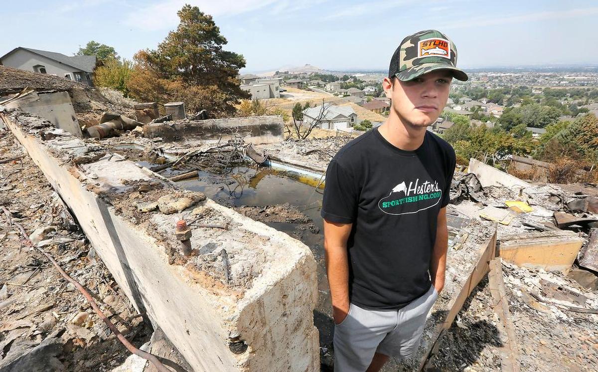 Tyler Miller stands near the concrete foundation of his parents’ house at 3403 W. 47th Ave. in Kennewick. Miller, a Benton County District 1 firefighter, got to the home in time to rescue relatives and pets.