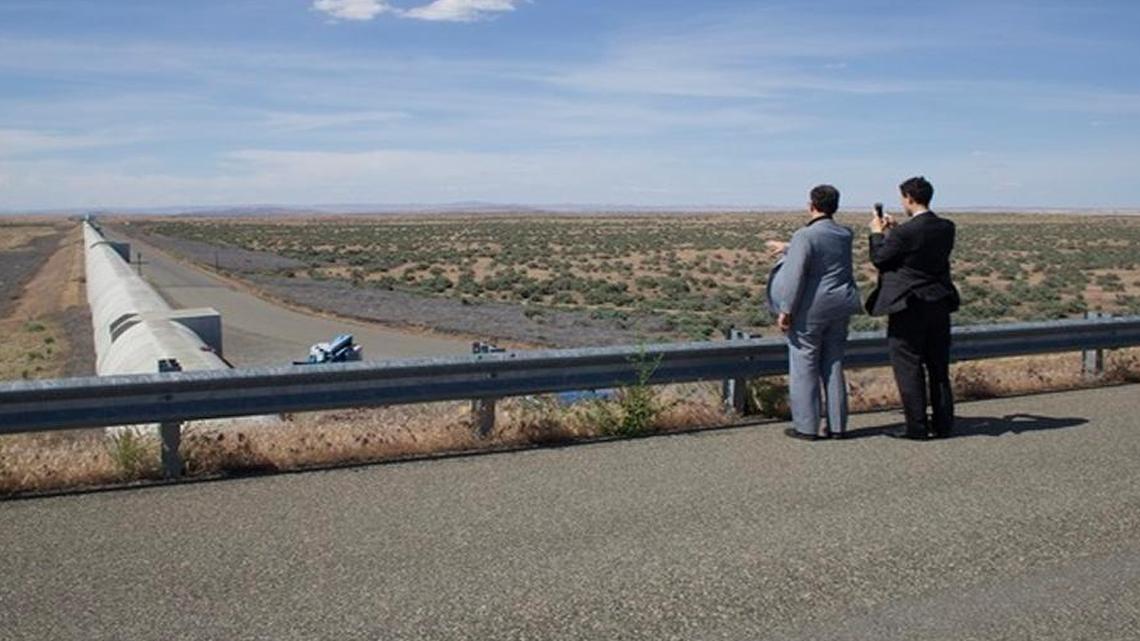 Visitors at Hanford LIGO look down one of two vacuum tubes extending 2.5 miles at right angles across the shrub steppe near Richland.
