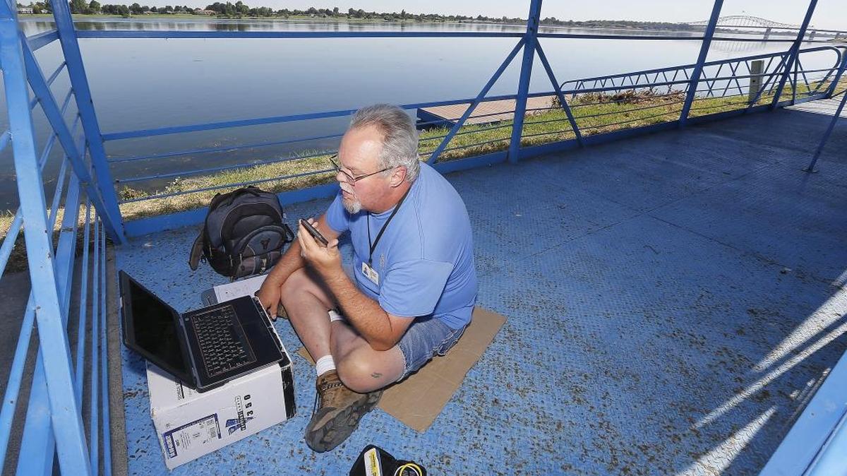 Allan Lusty, an employee of PocketiNet, sits in the empty Water Follies official barge in Kennewick’s Columbia Park setting up a modem for internet service for officials to use during the three-day boat racing and air show. The steel structure is set up each year at the start-finish line and will be packed with people starting Friday. Follow all the action at www.tricityherald.com and on Facebook and Twitter, #TCHydros.