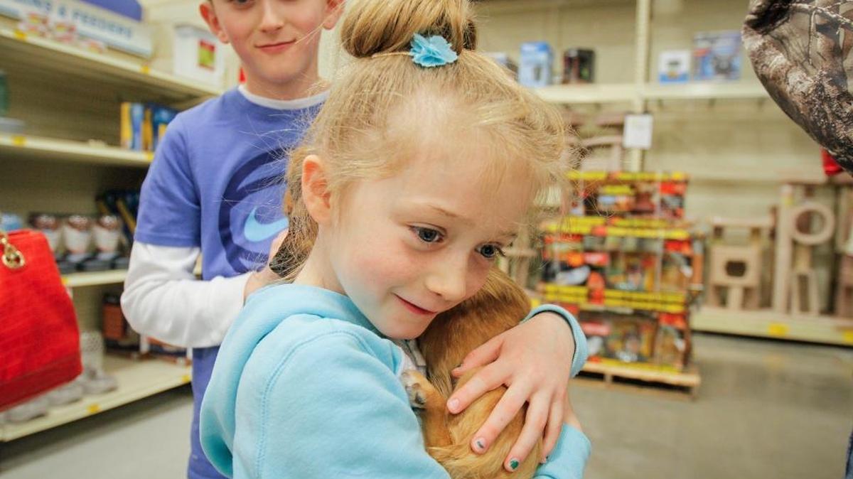 Rubi Cox, 6, hugs her new dog, Ginger.
