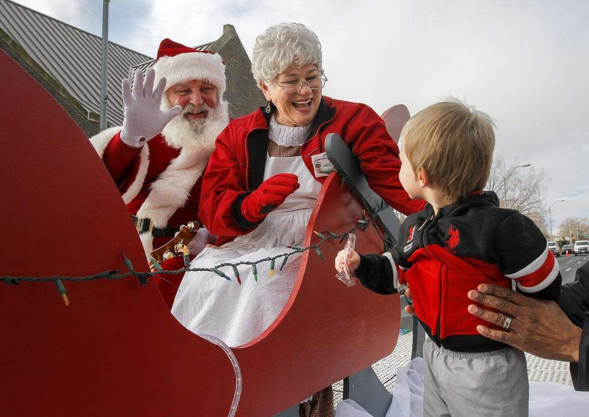 Mr. and Mrs. Claus wave to the crowd at the Numerica Hometown Holiday parade in downtown Kennewick.