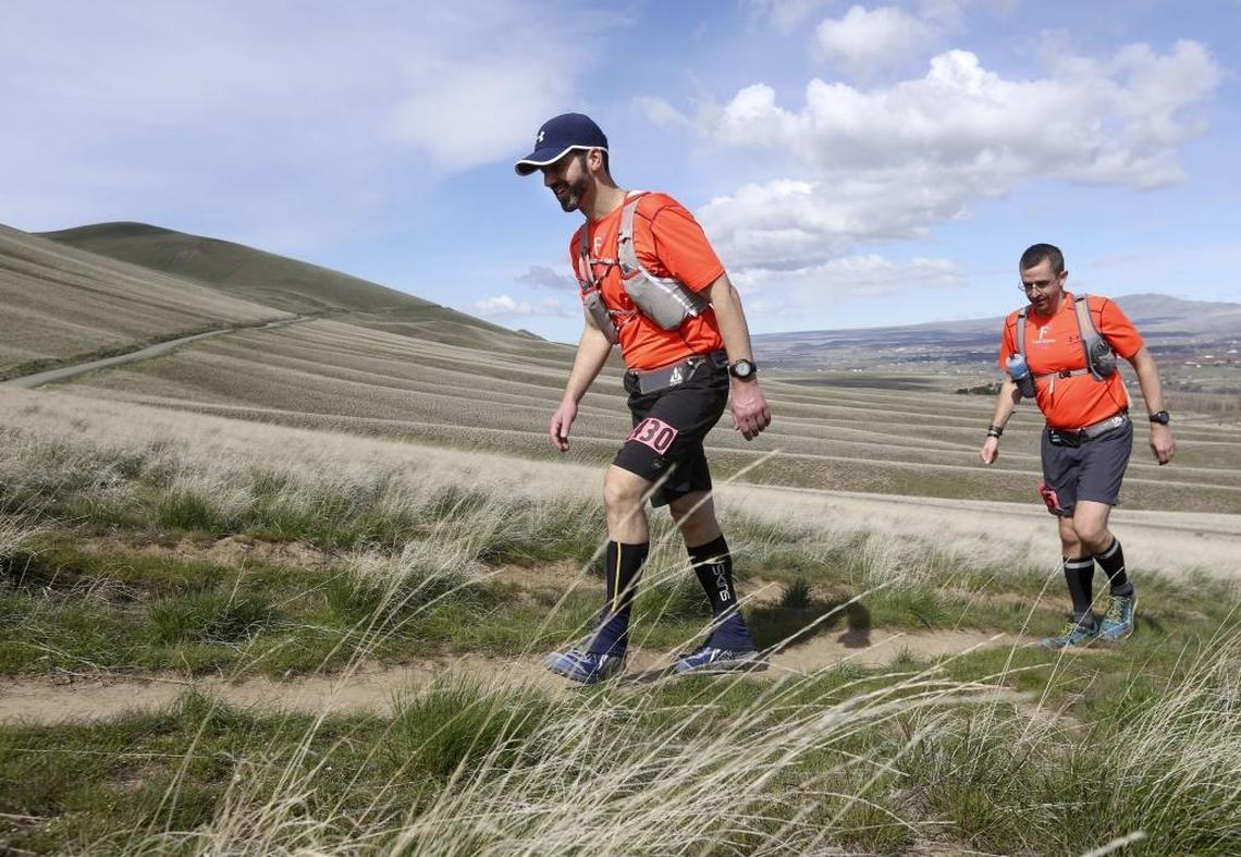 A pair of competitors hike up McBee Hill near Benton City. The Badger Mountain Challenge 50- and 100-mile races hit McBee as well as Badger and Candy mountains.