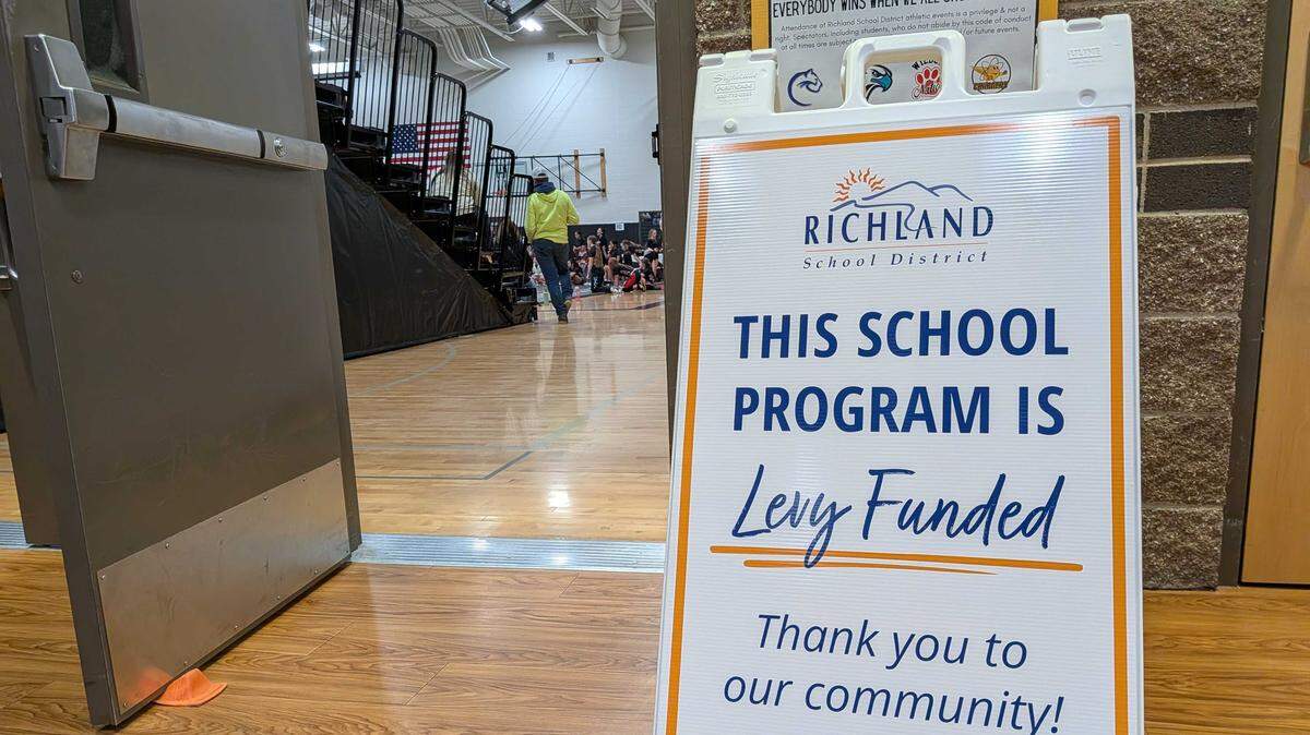 A sandwich sign outside a wrestling match at the Leona Libby Middle School gym in Richland thanks taxpayers for their support to fund extracurricular activities.