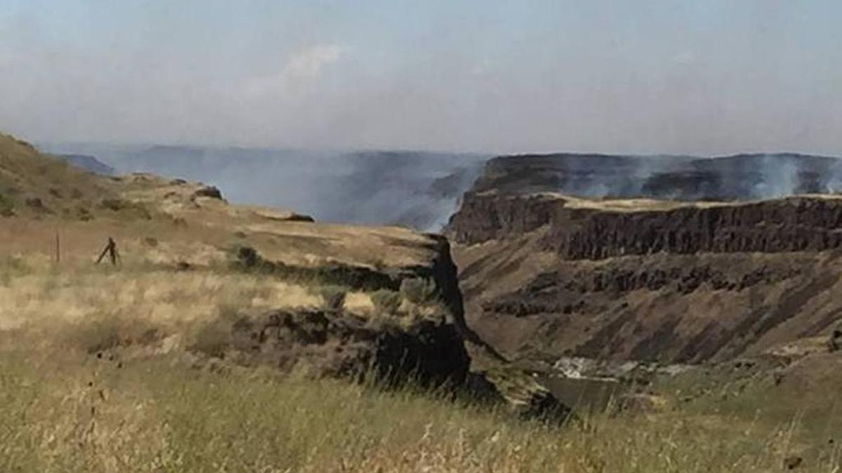 Todd Kupferer Jr., a firefighter with Franklin Fire District 1, shot this photo of smoke rising from the Palouse Falls fire near Washtucna. The lightning-caused blaze has burn 25,000 acres.