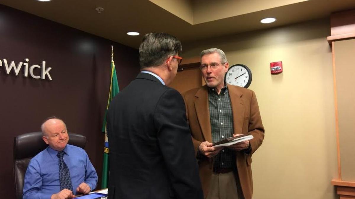 Port of Kennewick board President Don Barnes (right) presents a “Friend of the Port” award to CBC President Rich Cummins on Tuesday.