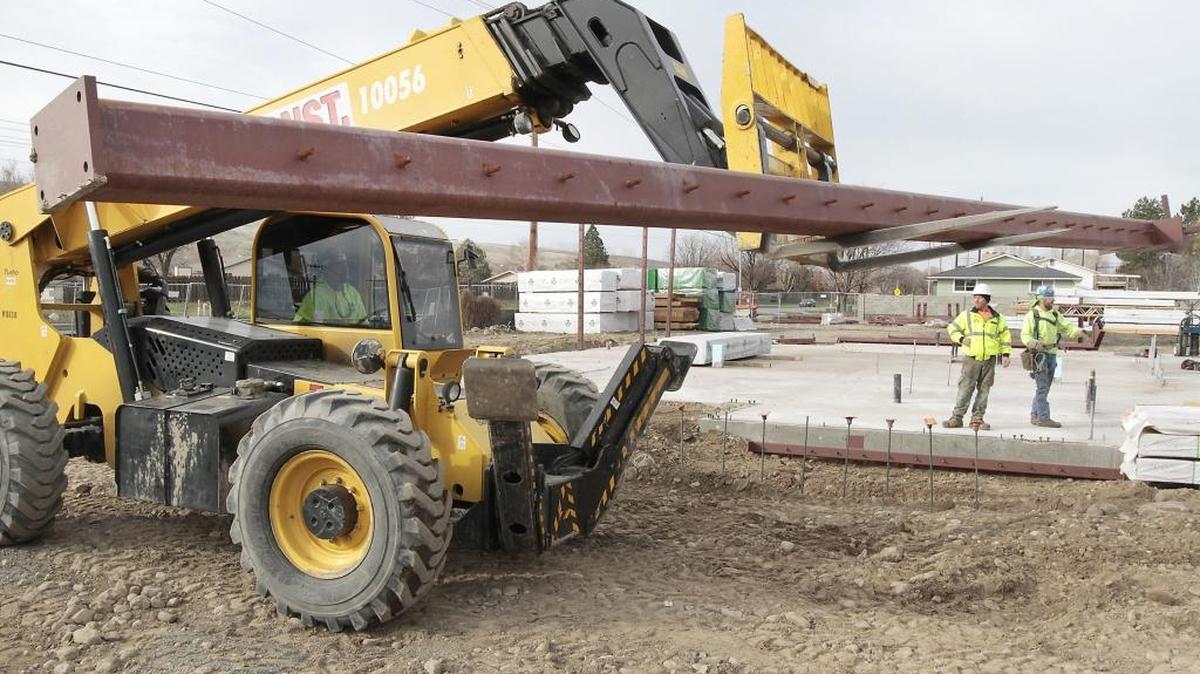 Construction workers prepare to lift a steel vertical support beam into place Wednesday at the construction site for the new Kennewick fire station at the intersection of West 10th Avenue and South Kellogg Street. Fire Station No. 5 is the first new Kennewick station in 20 years. It will feature a 12,000-square-foot building.