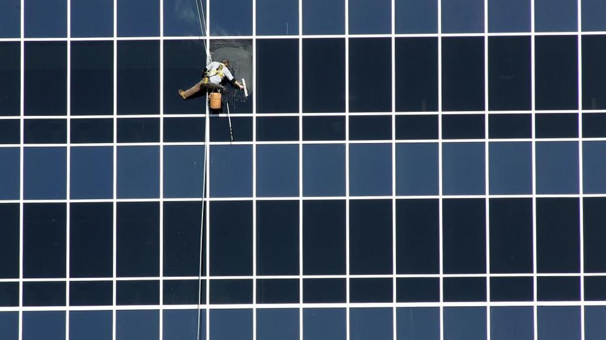 An employee of Sparkling Clean Windows washes windows under Monday’s skies on the 10-story River Pavilion tower at Kadlec Regional Medical Center in Richland. The hospital facilities manager estimates the tower has 425 windows to be regularly cleaned.