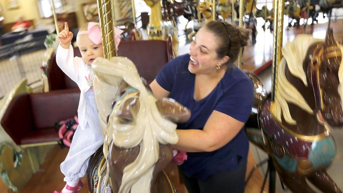 Denley McGuire, 1, rides Monday at the Gesa Carousel of Dreams with her mother, Caroline, during the first Ride-A-Thon fundraiser at the popular 107-year-old restored carousel. The McGuires of Kennewick were the first to arrive for the unlimited rides. The carousel foundation was hoping for 1,000 riders to make a $50 tax-deductible donation to help with ongoing care and maintenance of the historic horses. Watch a video at: tricityherald.com/video.