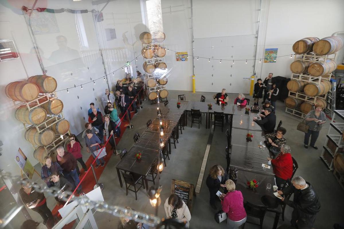 Locals wait in line to enter Monarcha Winery for a tour and wine sample after the Port of Kennewick held its ribbon cutting for the Columbia Gardens Urban Wine & Artisan Village in February 2018.