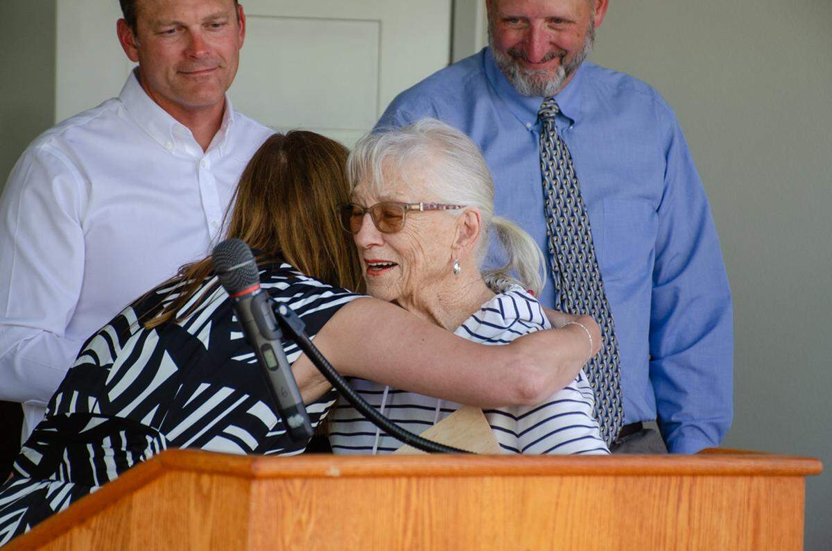 Laura Jones, director of Pasco School District’s career and technical education programs, embraces Helen Marshall during a Thursday ceremony celebrating the completion of the 26th home built by Team Pasco students and instructors. Marshall, 90, of Anacortes, is the mother of beloved construction teacher John Marshall, who passed in December.