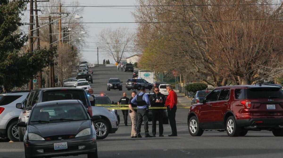 Pasco investigators work the scene of what they believe is a gang-related shooting at an apartment building parking lot on the 800 block of Seventh Avenue and West Ruby Street in Pasco. Police said the victim was shot two times.