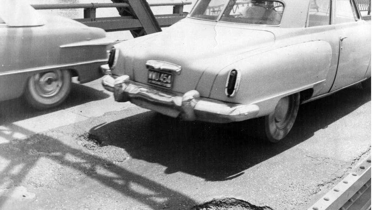 The old Pasco-Kennewick bridge was becoming a difficult and risky drive when this photo was published in 1962. Motorists swerving to avoid potholes were in danger of hitting oncoming traffic, as most road markings on the bridge had worn away. This near-accident was photographed by Tri-City Herald photographer Ralph Smith, who shot a number of traffic mishaps on the bridge.
