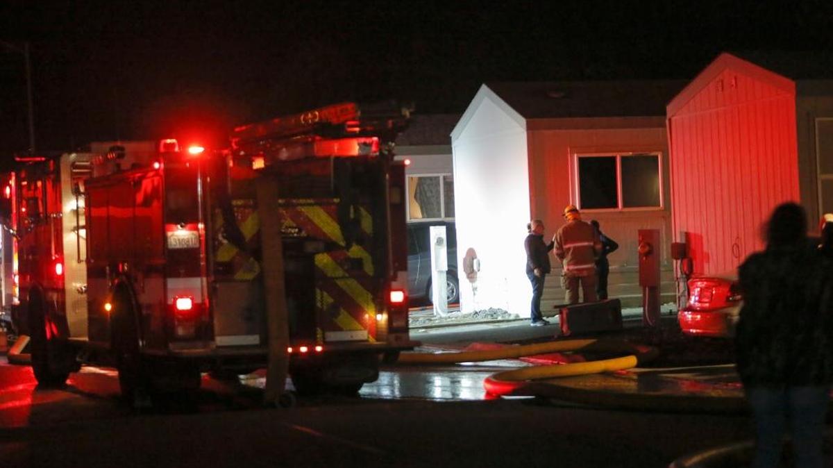 Fire fighters respond to a fire at a manufactured home near the Benton County Fairgrounds on Tuesday.