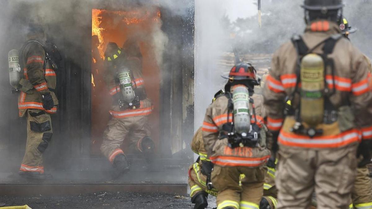 Groups of firefighters from around the Mid-Columbia region take turns Friday participating in live fire training exercises at the Joint Fire Training Center in Kennewick. About 500 firefighters from seven agencies are scheduled to attend 24 training sessions during an 11-day period, according to Capt. Kevin Landon of the Richland Fire Department. The last day of state-mandated training is April 1. Watch a video at tricityherald.com/video