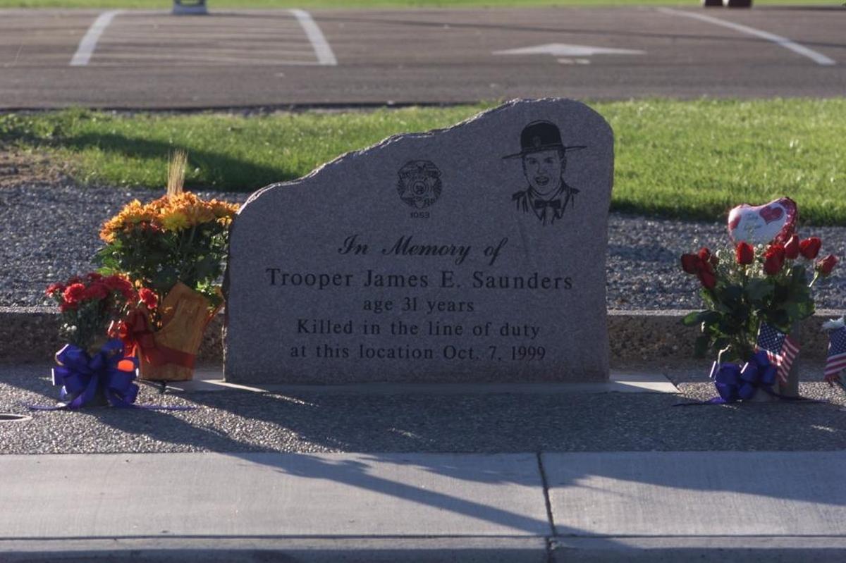 A granite slab engraved with the likeness of Washington State Patrol Trooper James E. Saunders sits in front of the Hillcrest-Bruce Lee Memorial Center in Pasco, just a few feet from where he was shot to death during a traffic stop on Oct. 7, 1999.