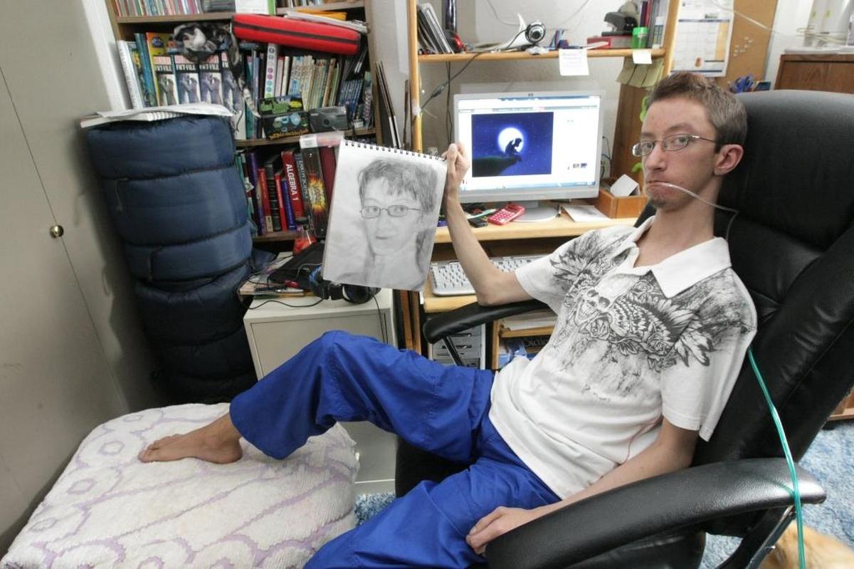 Jason Harris, in 2012, shows off some of his drawings in a sketch book and on the computer screen. The 26-year-old, who grew up in the Tri-Cities and battled a difficult illness, died the day before Thanksgiving.